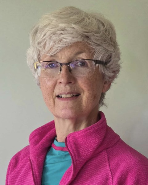 Yvonne in a pink fleece, smiling